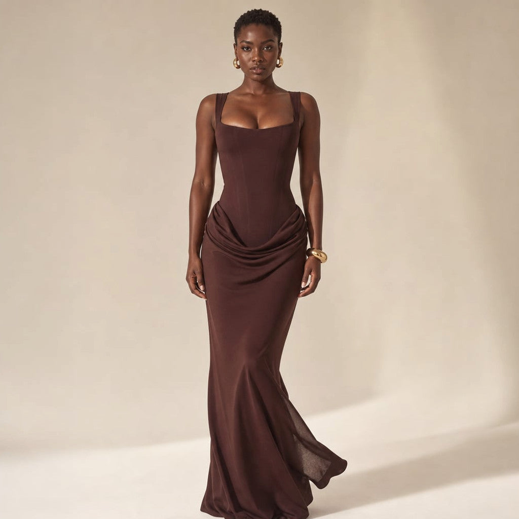 Model wearing Rysa black floor-length bodycon dress with open back, photographed from behind to show the vertical backless cut
