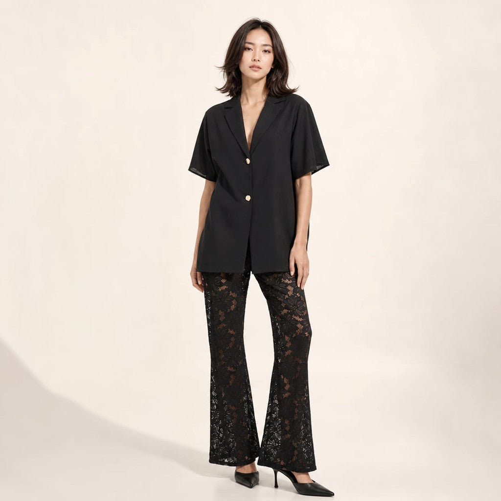 Front view of the Jordan two-piece set in black — short-sleeve cotton V-neck top with gold button and sheer lace wide-leg trousers, full-length silhouette on a white background.