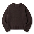 Model wearing the Paenus chocolate cotton crew neck knit jumper with straight-leg trousers