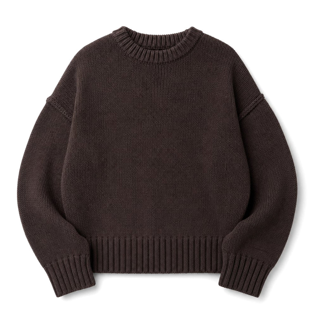 Model wearing the Paenus chocolate cotton crew neck knit jumper with straight-leg trousers