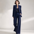 Model wears Vael tailored co-ord in navy blue, stand collar fastened, wide-leg trousers falling straight to the ankle