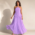 Model wearing purple pleated ruffle halter maxi dress with bare shoulders, full-length silhouette