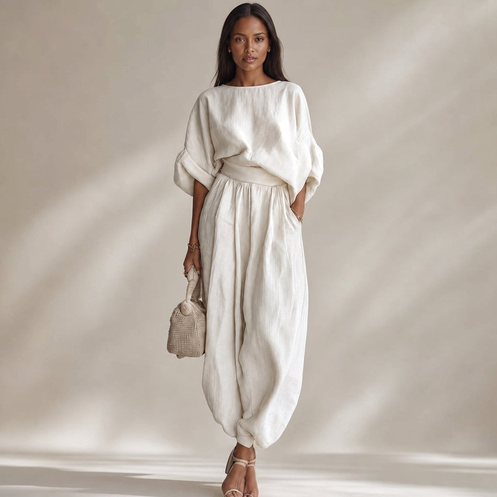 Sael linen two-piece set in white — wide-leg trousers and draped blouse on a model, full-length front view