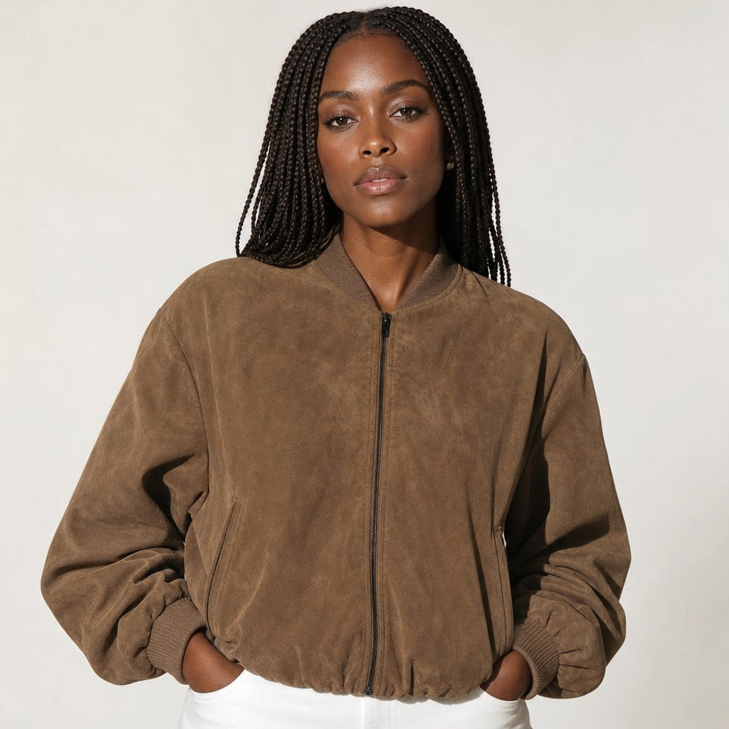 Model wearing Clara brown snake-texture bomber jacket over straight-leg trousers, showing structured shoulder and elasticised cuffs