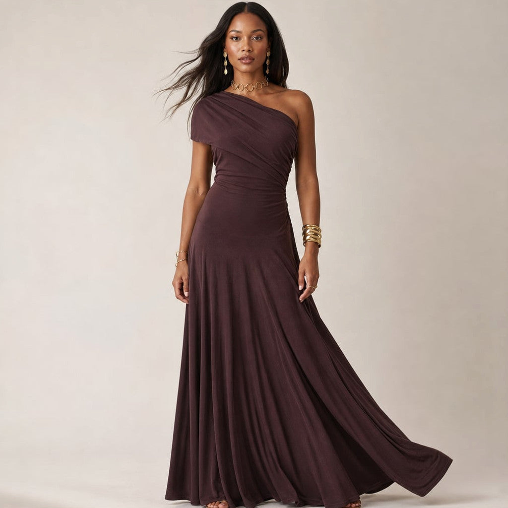 Brown one-shoulder pleated maxi dress with full-length flowy skirt on a model, front view
