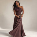 Model wearing brown asymmetric one-shoulder floor-length pleated dress, full-length shot