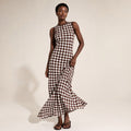 Model wearing the Linae chocolate spot sleeveless maxi dress, photographed from the front showing the relaxed fit and open shoulder.