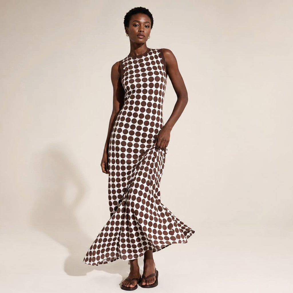 Model wearing the Linae chocolate spot sleeveless maxi dress, photographed from the front showing the relaxed fit and open shoulder.
