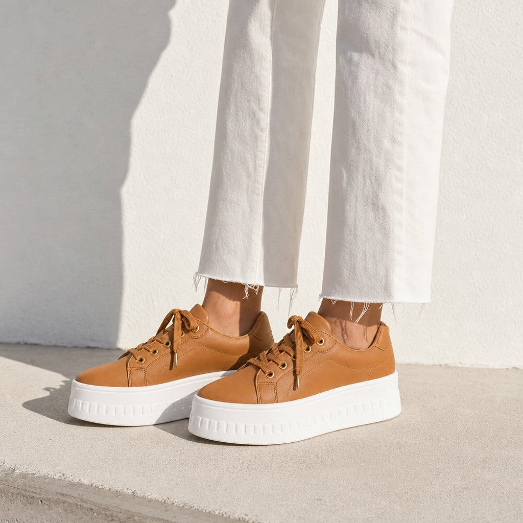 Chunky platform lace-up sneakers in tan with a thick evenly stacked sole and structured straight-lace closure