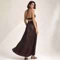 Model wearing the Saesan chocolate maxi dress with halter tie neckline and close-fitting bodice, photographed at full length
