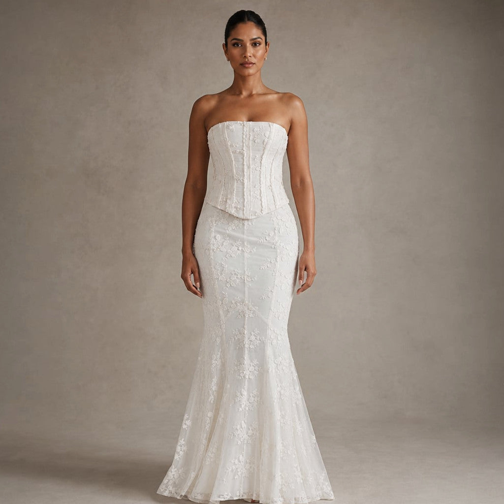 Model wearing white lace strapless corset mermaid gown, full-length silhouette showing thigh-to-floor flare