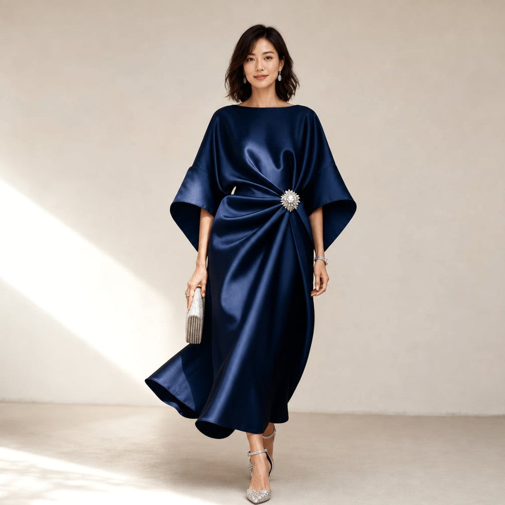 Model wearing Melo navy knit midi dress with kimono sleeves and crystal brooch, full-length editorial shot
