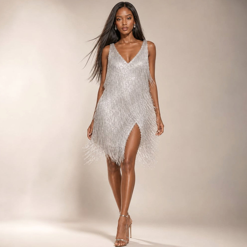 Front view of sequin fringe tiered mini dress with deep V-neckline in silver, shown on model against neutral background