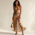 Model wearing the Ruva ruched knit midi dress with ruffled sleeves and multicolour print, front slit visible at hem