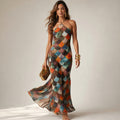 Model wearing the Fiadar body-skimming maxi dress with geometric scale print, photographed from the front at floor length.