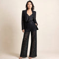 Varis two-piece floral lace set in black — single-button peplum blazer with notch lapel and matching wide-leg trousers, front view on white background