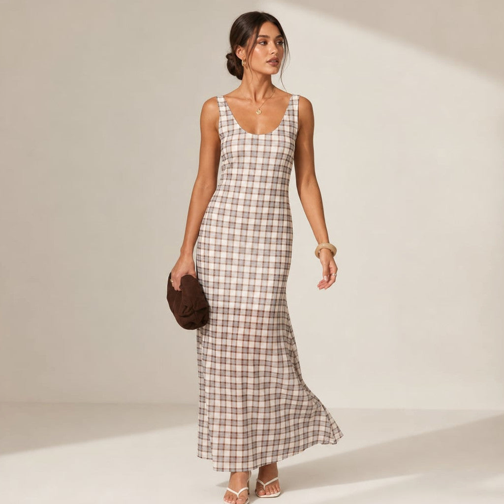 Model wearing neutral check sleeveless maxi dress with sheer overlay layer over fitted mini lining, photographed at full length